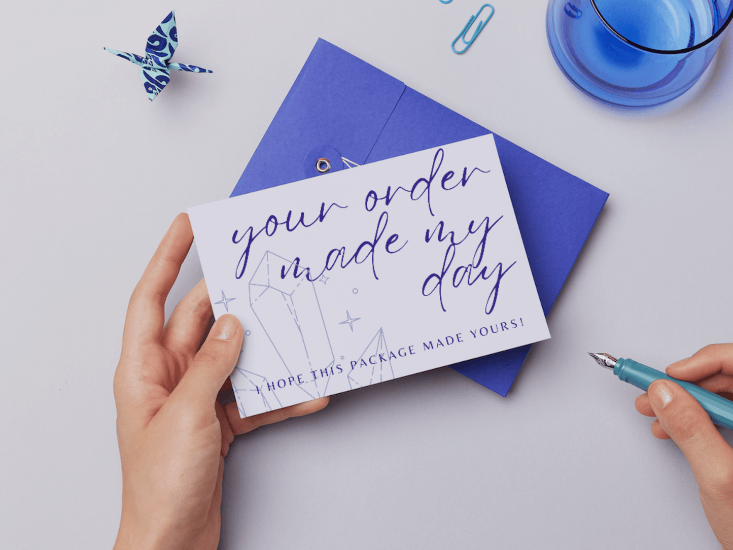 You can see a hand holding an aesthetic and boho your order made my day card template which says "your order made my day, I hope this package made yours!". Perfect for business owners and content creators. It's editable in Canva.